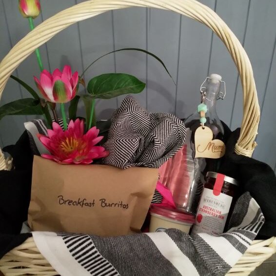 A handmade hamper basket with items inside