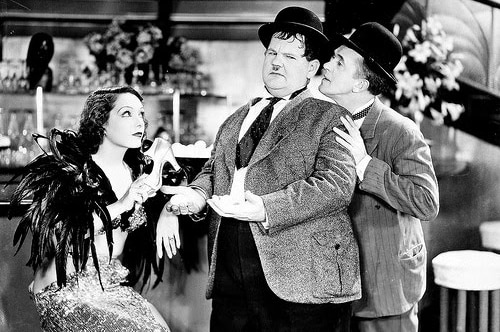 Black and white still of Lupe Vélez and comedy duo Laurel & Hardy in 1934 film Hollywood Party.