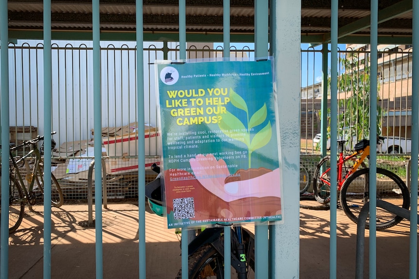 A laminated A4 sign on a fence headlined 'Would you like to help green our campus?'