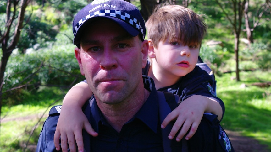 Michael carries Max on his back during one of their practice walks.