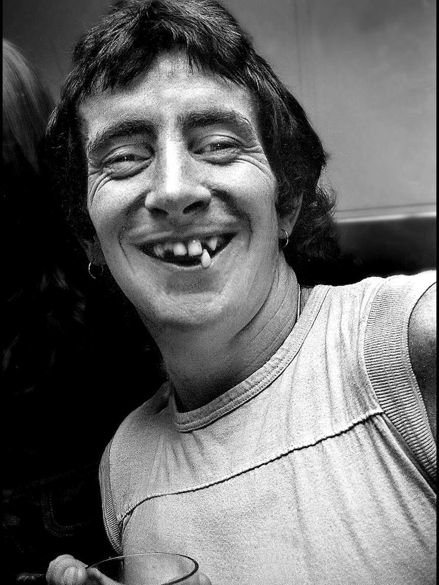 headshot bon scott showing missing and crooked teeth in big smile
