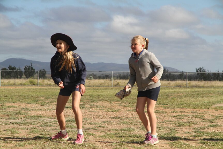 Two students playing on the oval at Mistake Creek State School.