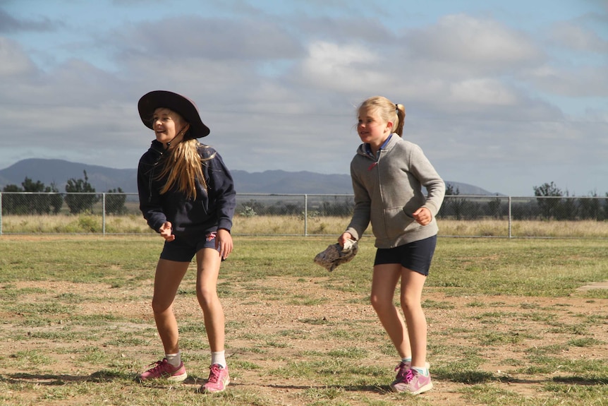 Two students playing on the oval at Mistake Creek State School.