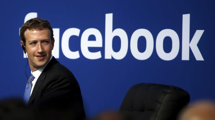 Facebook CEO Mark Zuckerberg is seen on stage during a town hall.