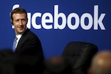 Facebook CEO Mark Zuckerberg is seen on stage during a town hall.