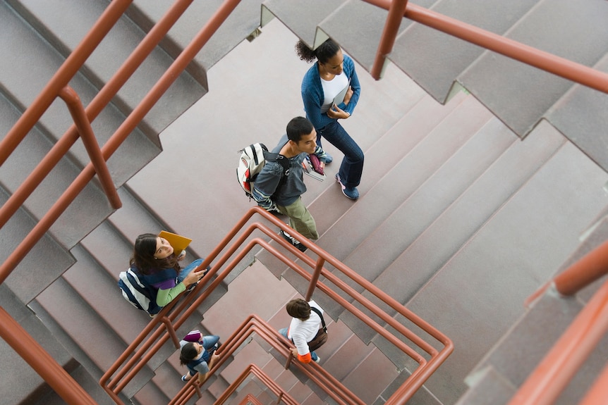 Group of students walking up and down staircase