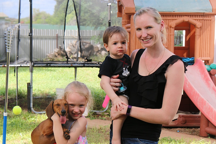 Teacher Olivia Davis in her backyard at Mount Isa with her children in February 2017