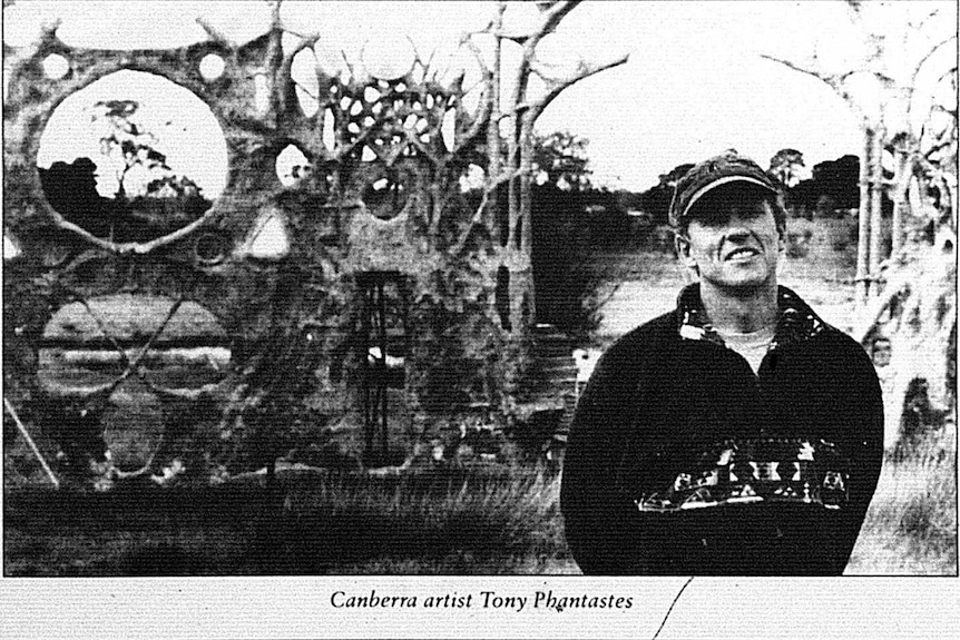 Young artist Tony Phantastes stands in front of his gothic-looking artwork Dreamers Gate in 1995