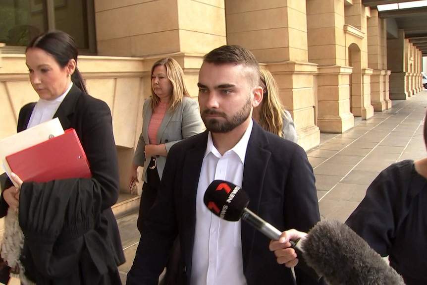 A man outside an Adelaide court with his lawyer.