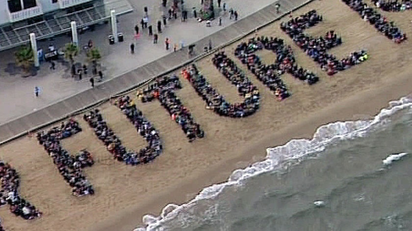 Human climate change sign on Sty Kilda beach. (ABC)