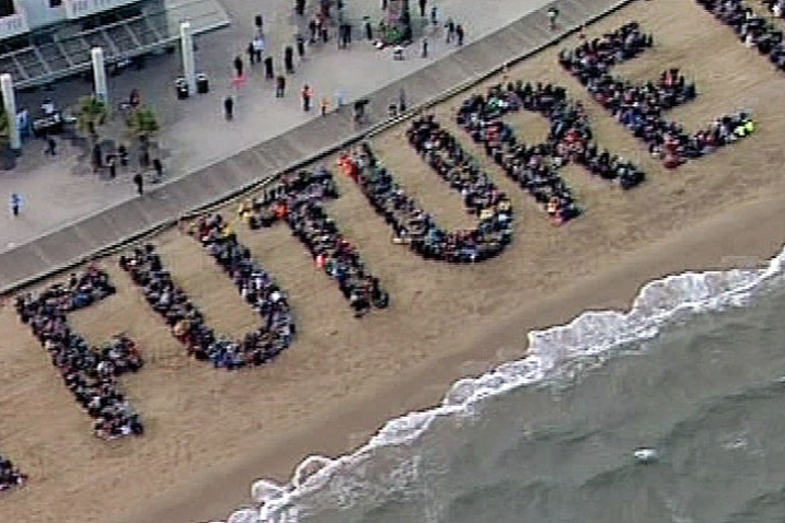 Human climate change sign on Sty Kilda beach. (ABC)