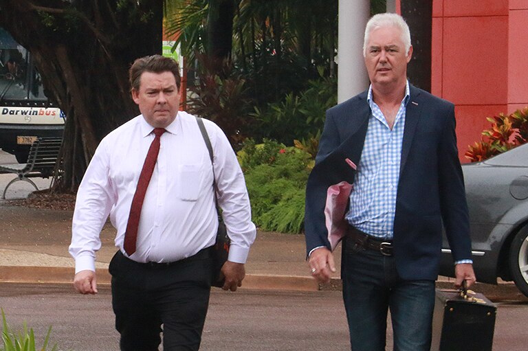 Former NT Police Commissioner John McRoberts (right) walks into court with his lawyer Anthony Elliot.