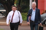 Former NT Police Commissioner John McRoberts (right) walks into court with his lawyer Anthony Elliot.