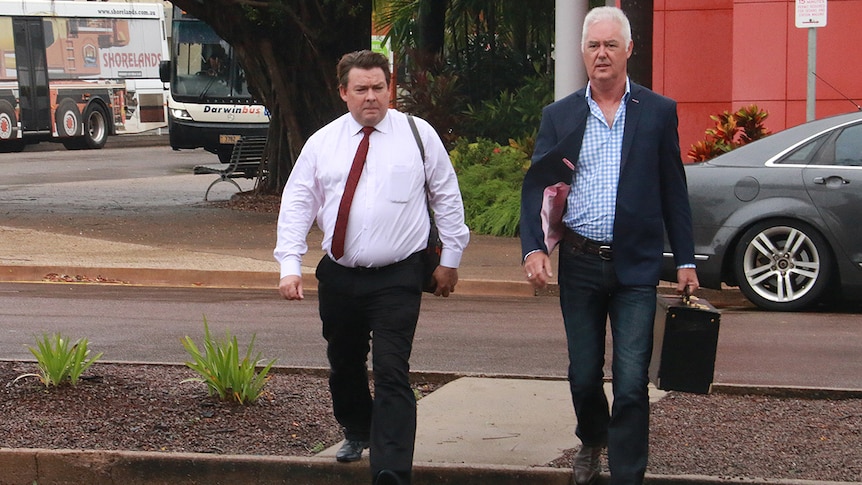 Former NT Police Commissioner John McRoberts (right) walks into court with his lawyer Anthony Elliot.