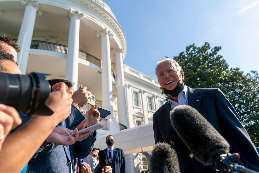 President Joe Biden speaks with reporters before boarding Marine One