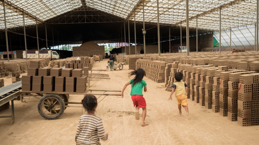 Children play in brick factory in Cambodia.