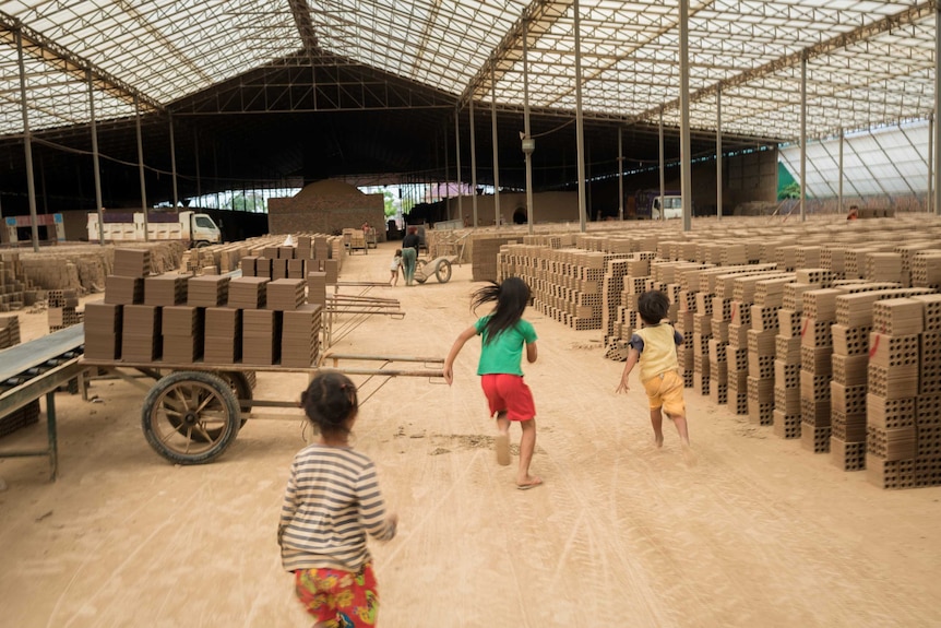 Children play in brick factory in Cambodia.