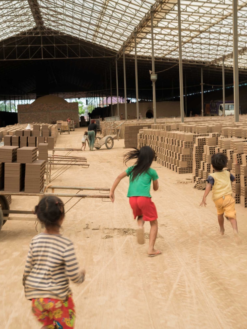 Children play in brick factory in Cambodia.