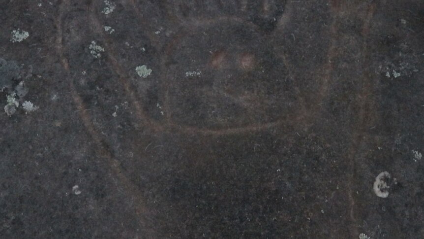 A rock carving shows a human figure.