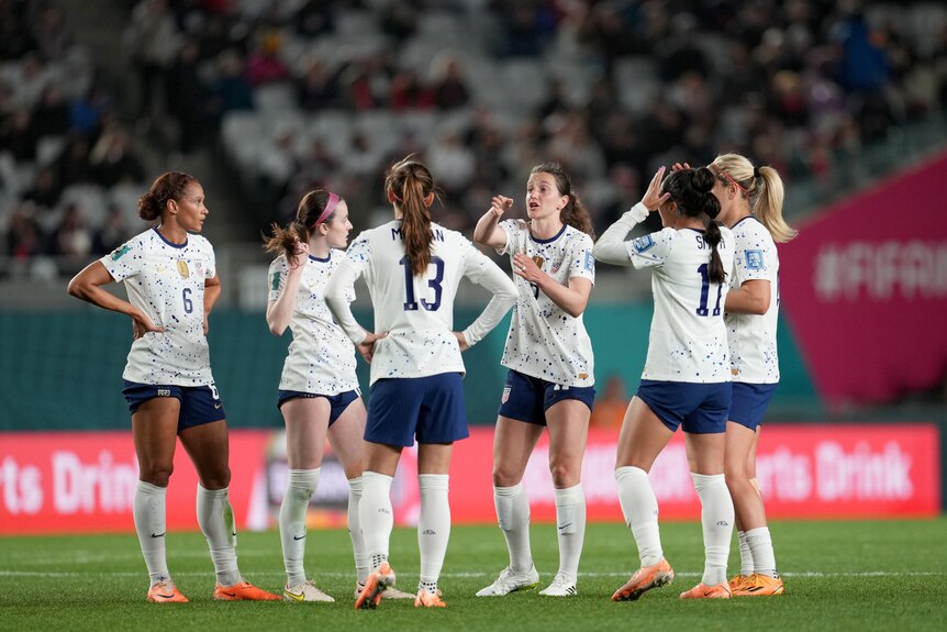 A United States footballer gestures and points at her teammates during a break in play in a Women's World Cup game.