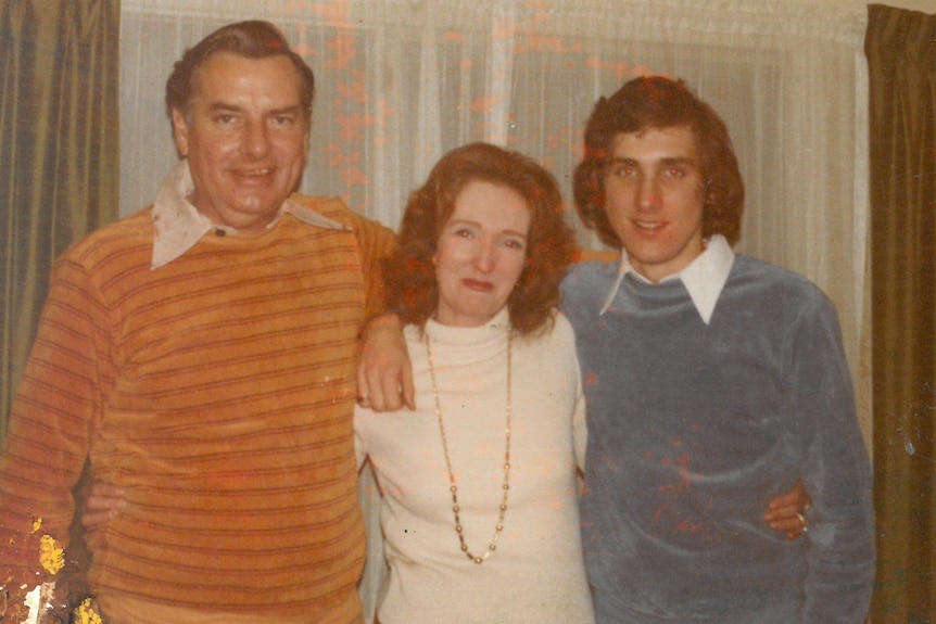 A 1970s photo of a middle-aged couple and a young man.