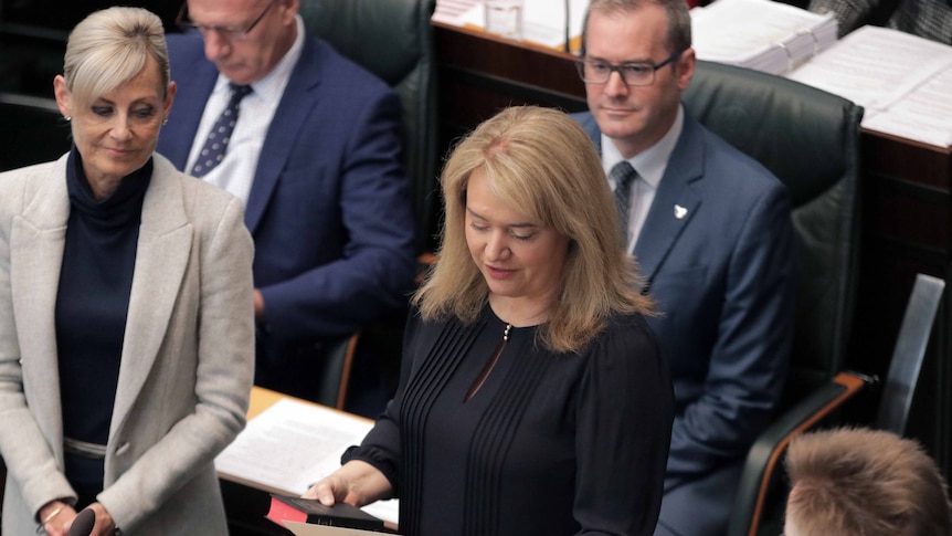 Madeleine Ogilvie is surrounded by members of the Liberal Government as she takes the oath.