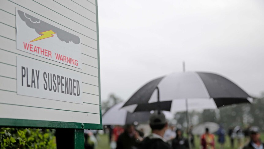A sign showing play is suspended due to weather during the par-three competition at the Masters.