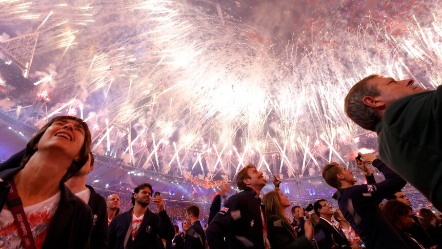 Athletes watch the fireworks show at the closing ceremony of the London 2012 Olympic Games.