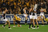 Steele Sidebottom, Harry O'Brien and Dale Thomas celebrate after Collingwood's thrilling win over Hawthorn.