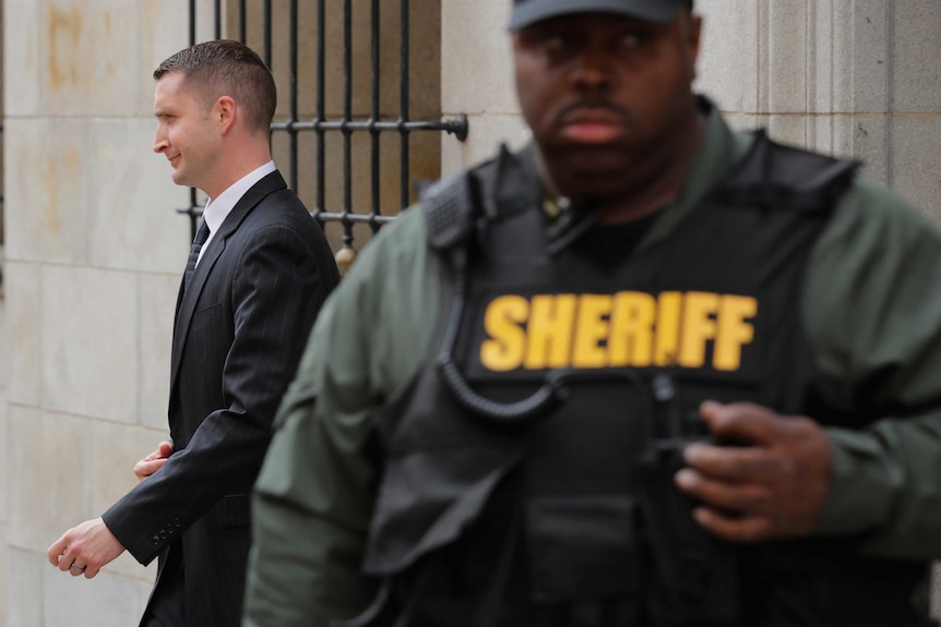 Police Officer Edward Nero walks out of court.