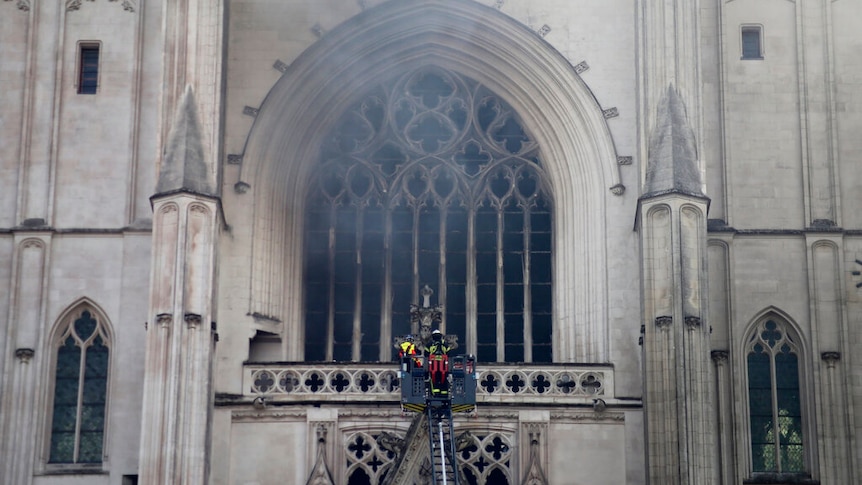 Fire fighters brigade pictured working to extinguish the blaze at St Paul Cathedral in Nantes, France.