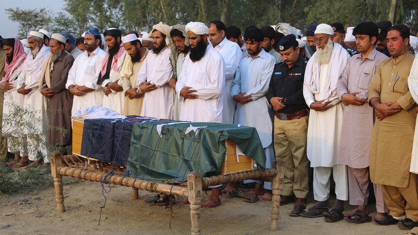 Local residents offer the funeral prayer of an intelligence officer in Charsadda, Pakistan, Monday, Oct. 24, 2016.