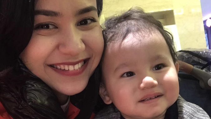 Nadila Wumaier smiles at the camera beside her two-year old son Lutfy in this selfie photo.