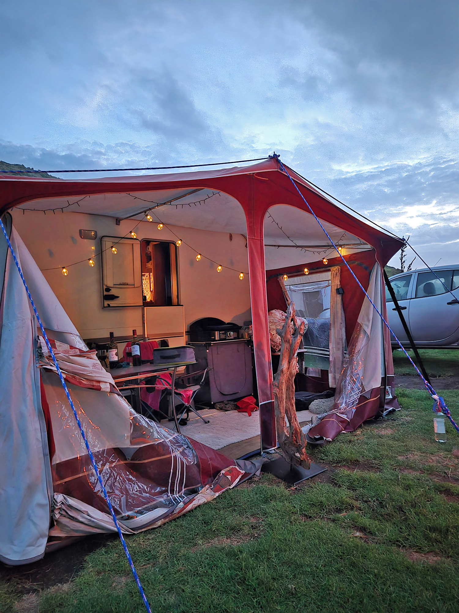 A tent set up near the campervan.