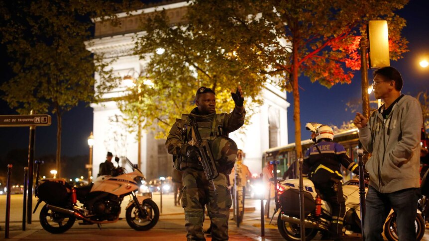 An armed soldier secures a Champs Elysee side street in Paris following a fatal shooting
