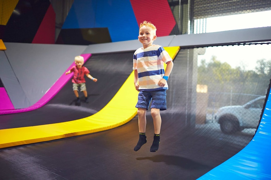 two young boys bouncing on brightly coloured trampolines at Bounce