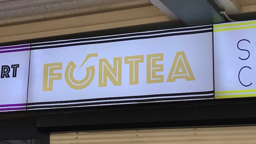 An illuminated Fun Tea sign.