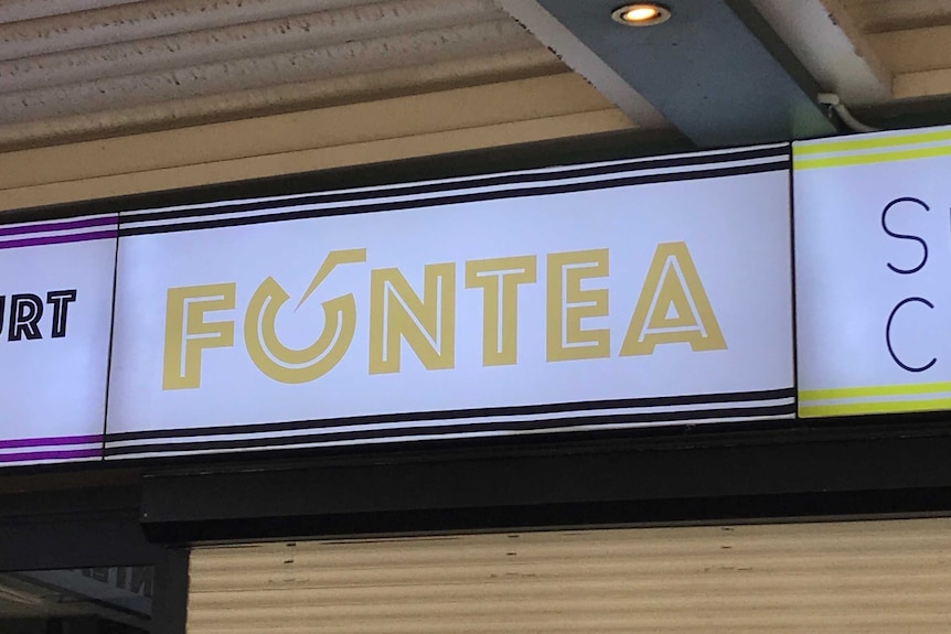 An illuminated Fun Tea sign.