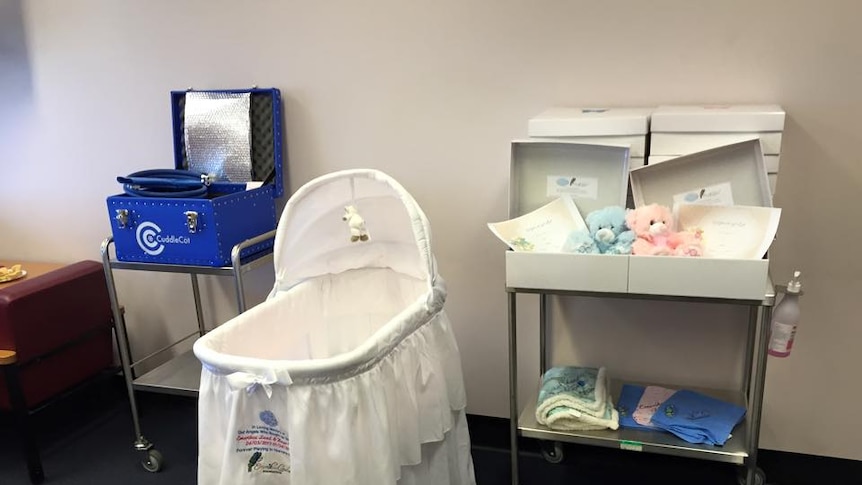 A cold Cuddle Cot bassinet and cooling machine.