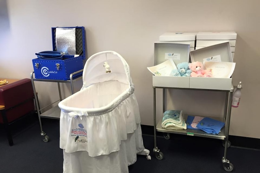 A cold Cuddle Cot bassinet and cooling machine.