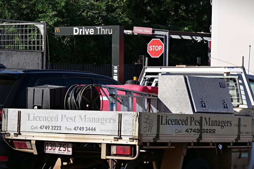 A work vehicle reading 'Pest managers' on the side parked at a MacDonald's parking lot