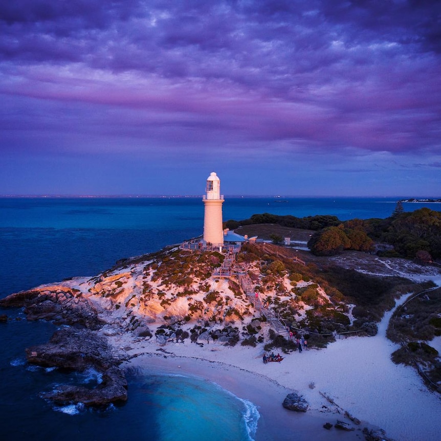 A lighthouse with the purple light of the dusk.