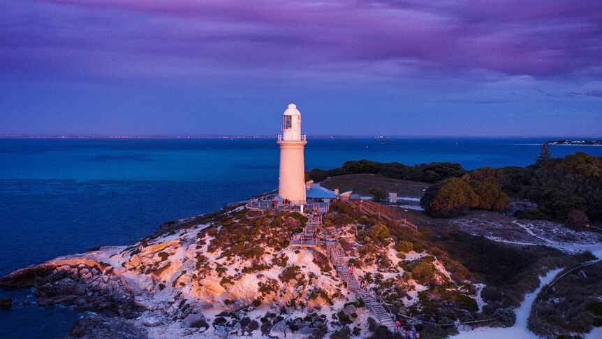 A lighthouse with the purple light of the dusk.