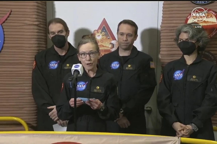 NASA Mars simulation crew members speak in front of media after exiting the simulation