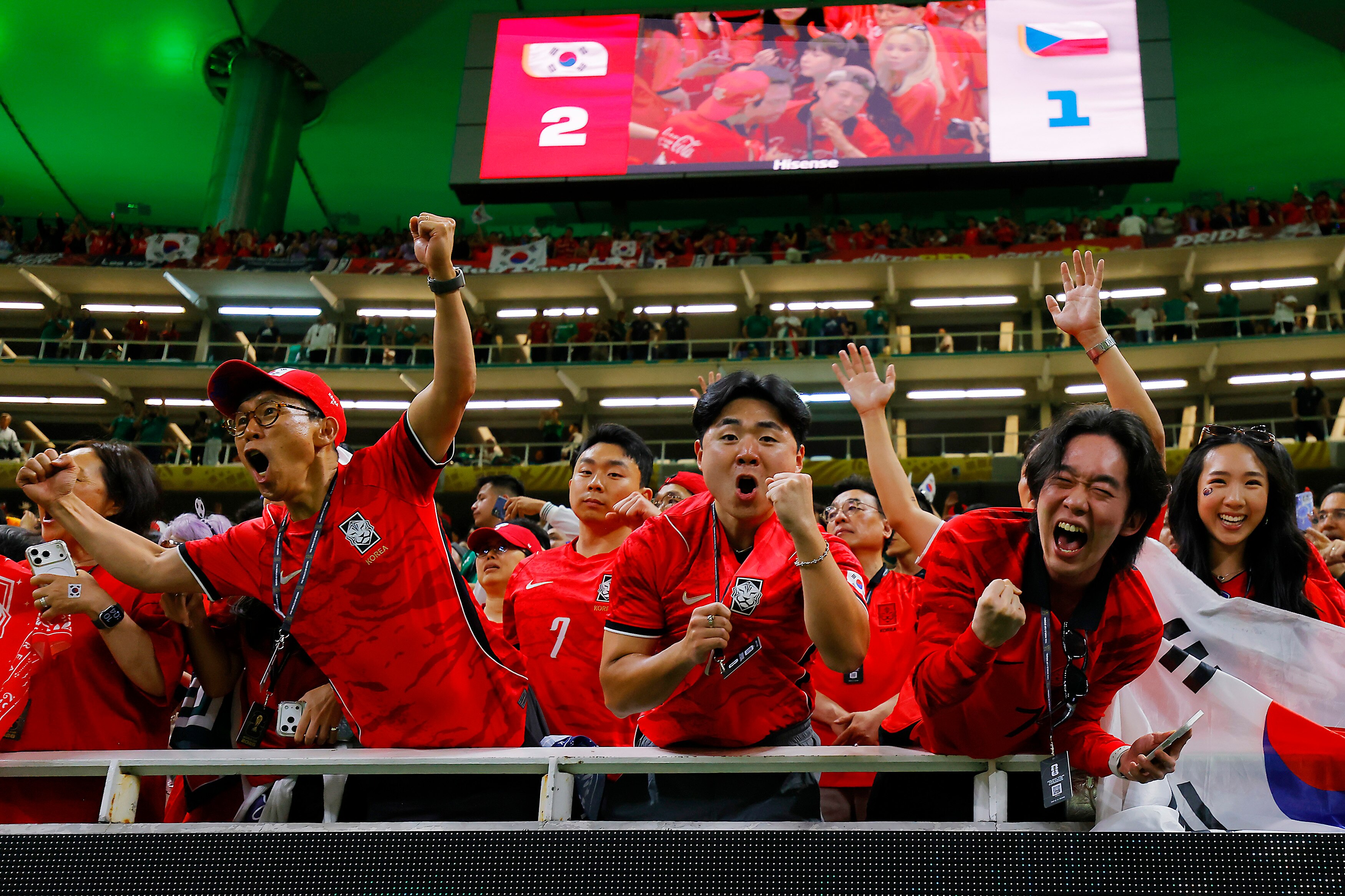 South Korean football fans wave, cheer and punch the air in celebration after their team's World Cup win.