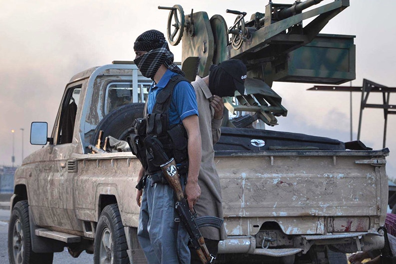 Fighters of the Islamic State stand guard at a checkpoint in the northern Iraq city of Mosul.