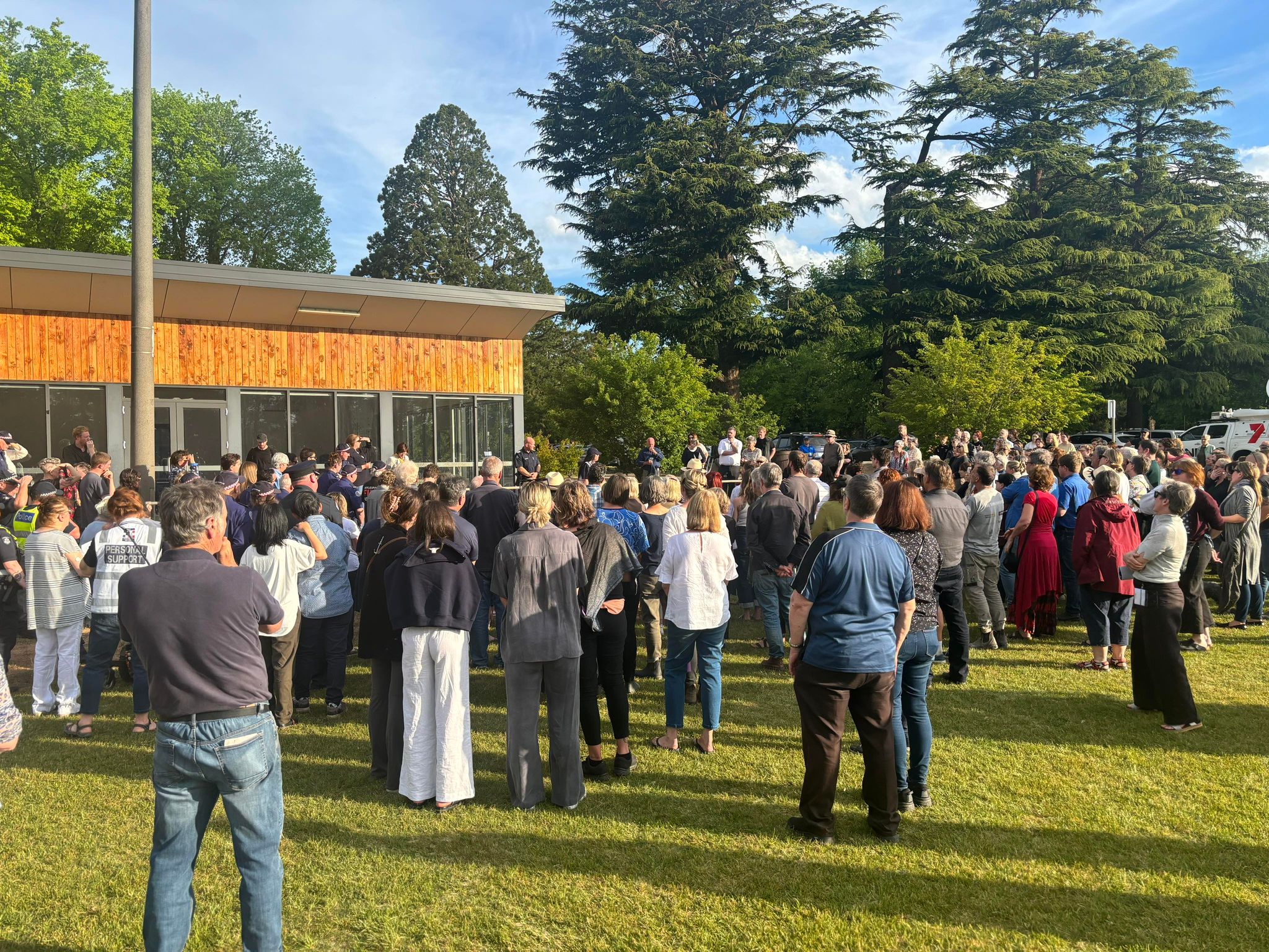 a large crowed of people gathering in a park