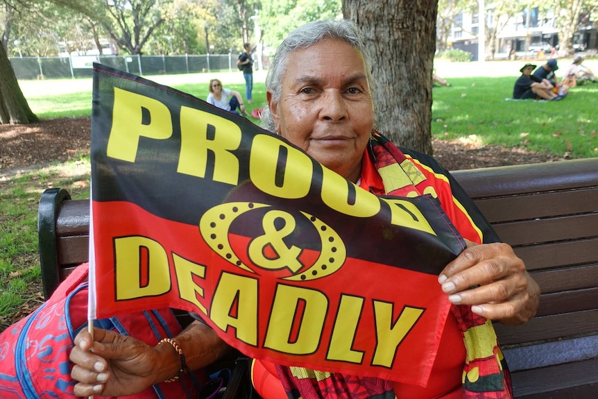 An Aboriginal elder holds a flag in Hyde Park in Sydney.
