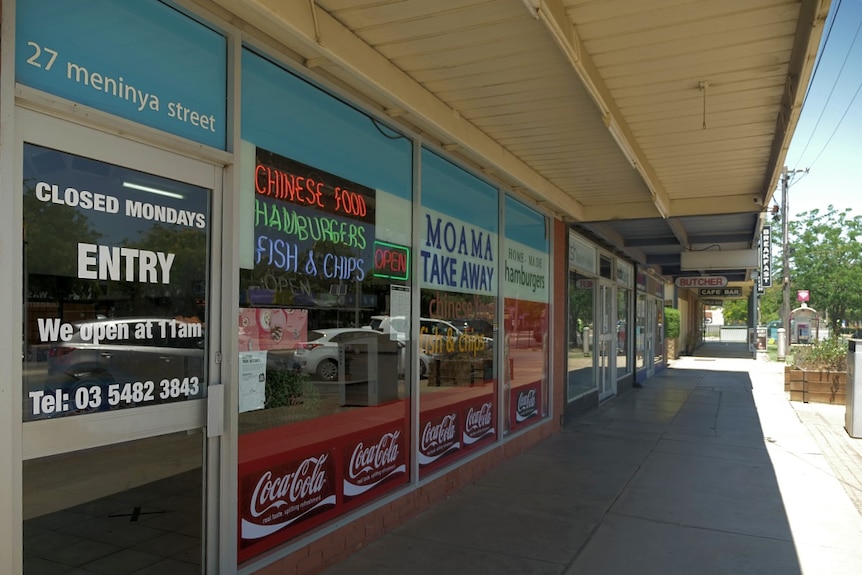 A quiet street lined with shops.