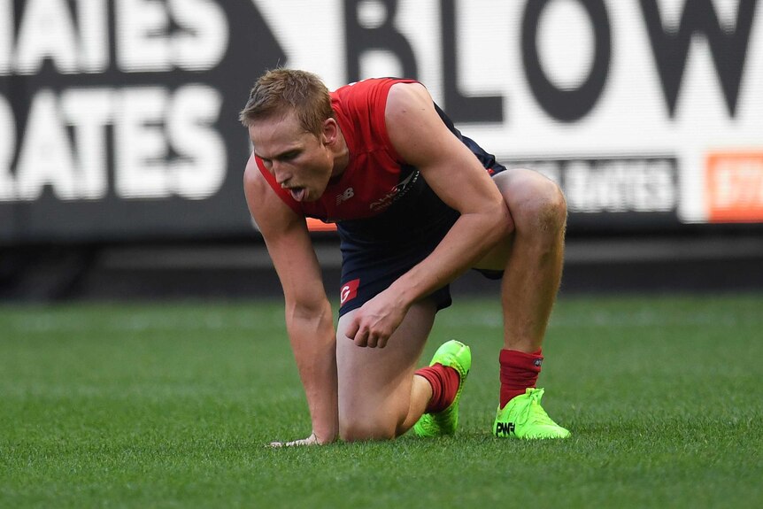 Bernie Vince attempts to recover his breath after an altercation with Ben Cunnington.